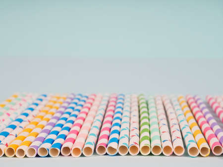 Many colored tubes in a row on a blue background.の写真素材