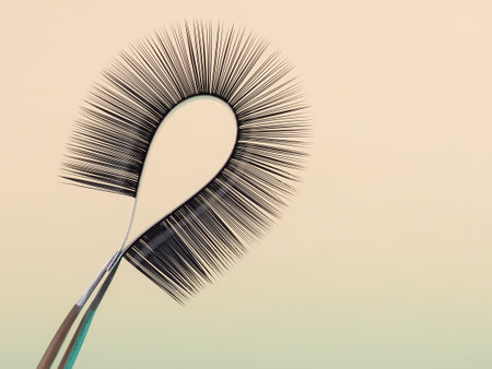 strip for eyelash extensions on a uniform tone, twisted, held with tweezers. Industry artificial eyelashes, eyelash extensions, beautyの写真素材