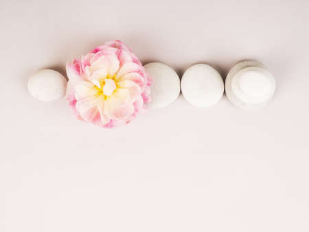Spa still life with zen stones and flower, Harmony and balance, cairns, simple poise stones on gray background, rock zen sculptureの写真素材