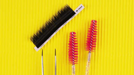 False eyelashes and brushes for the master on a yellow background.の写真素材
