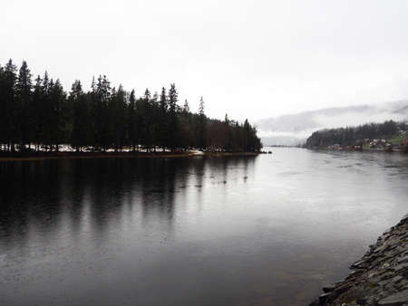 Gloomy landscape with fog on Norwegian fjords.の写真素材