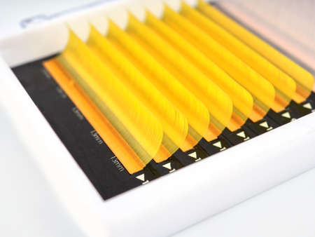 Multi-colored artificial eyelashes for extension, two colors in the macro palette, yellow and whiteの写真素材