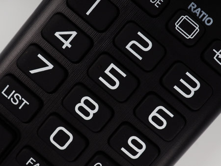 TV remote control, close-up buttons, tinted remote control parts.