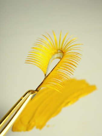 Gold eyelash extensions, Yellow Tweezers.の写真素材