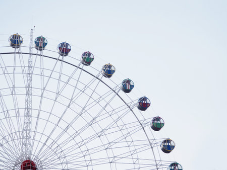 Abstract background, Ferris wheel with booths against the sky, space for text.