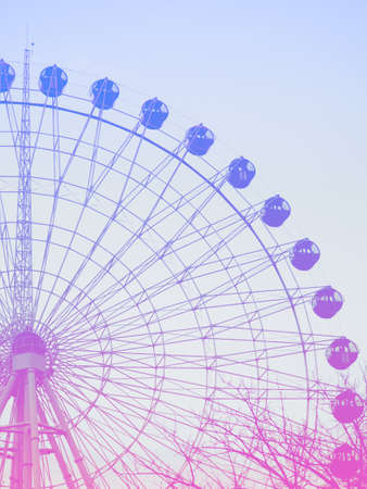 Abstract background, Ferris wheel with booths against the sky, space for text.の写真素材