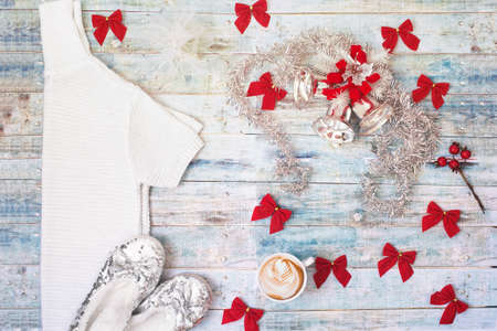 Christmas and New Year party celebration, female composition: blouse, ribbons, cup of coffee, shiny slippers. Blue vintage wooden background.の写真素材