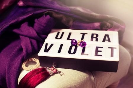 Composition of text frame worded ultra violet with female accessories.