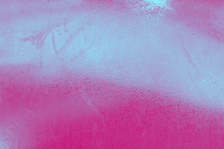 Abstract water drops steam on glass, toned in pink and blueの写真素材