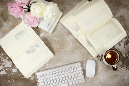 Opened book, glasses, roses, vintage tray, croissants, gifts and coffee cup on white background. Flat Lay top view.の写真素材