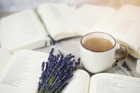 Top view to opened books lavender flowers, vintage tea cupの写真素材