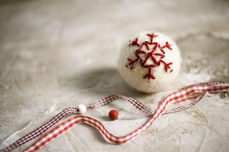 Christmas tree toy and decoration like red ball on light grunge surface with copy space close-up selective focusの写真素材