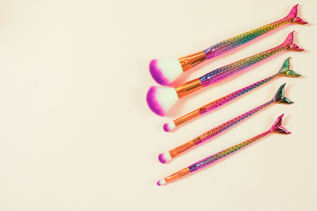 Set of mermaid tail make-up brushes. Make up tools on pastel backgの写真素材