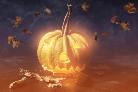 Scary Halloween pumpkin on a black background. Scary glowing face trick or treatの写真素材