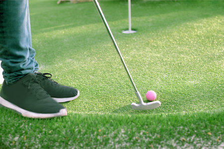 Golf ball and Golf Club on Artificial Grass.