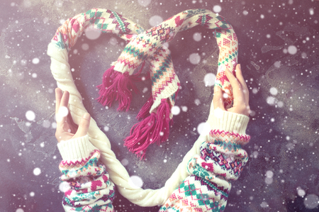 Heart made of a winter Christmas scarfの写真素材