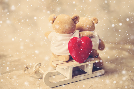 two teddy bears holding in ones armsの写真素材