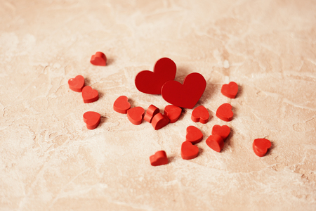 Valentines day concept. Couple of red wooden hearts on wooden background.の写真素材