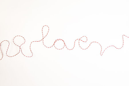 Word love made of red ribbon, on white background