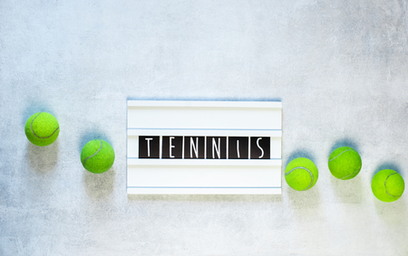 tennis balls and a racket on white background, with copy spaceの写真素材