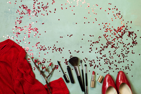 Top view to Valentines day party outfit composition red shoes accessories hearts simple background.の写真素材
