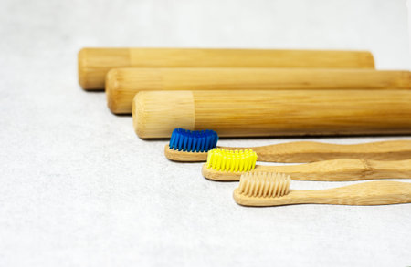 A family set of wooden bamboo toothbrushes on white background