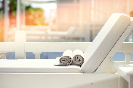 Sun bed beside swimming pool. Vintage filter.の写真素材