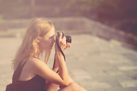 Woman with camera on the street.の写真素材