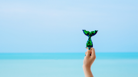 Mermaid sequin tail with turquois seascape in backgroundの写真素材