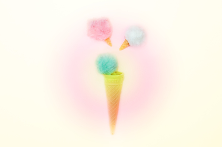 Creative top view flat lay of pastel color fluffy fur ball in ice cream waffle coneの写真素材