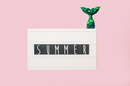 Summer - text on a display lightbox on pink bright background.の写真素材