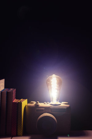 A vintage lamp made as an old film camera on cement background