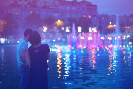 Two people enjoying evening city lights in Tiranaの写真素材