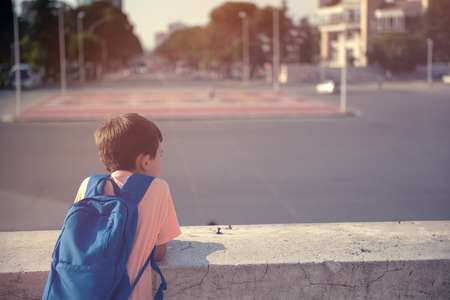 Back to school first day kid carrying backpack walking up school stairsの写真素材