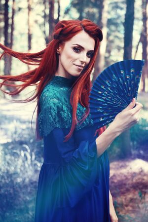 Female portrait with peacock feather on foreground. beauty makeup.の写真素材