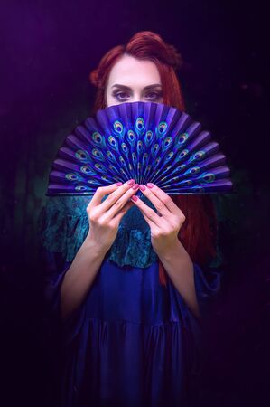 Female portrait with peacock feather on foreground. beauty makeup.の写真素材