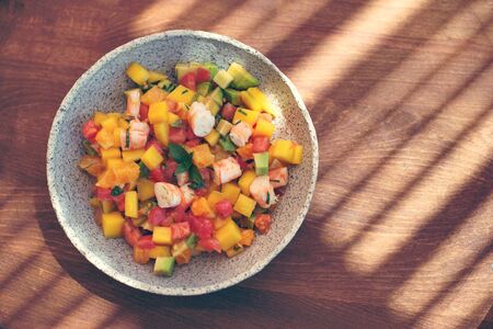 Delicious fruits salad in plate on table close-upの写真素材