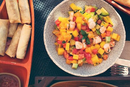 Delicious fruits salad in plate on table close-upの写真素材