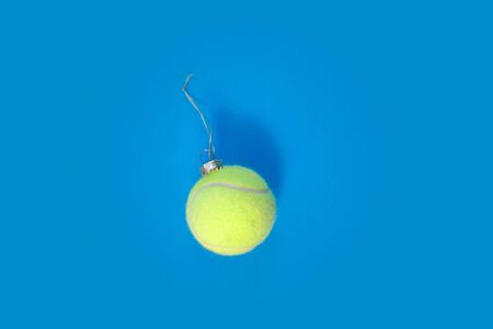 tennis ball ornament over blue hard court backgroundの写真素材