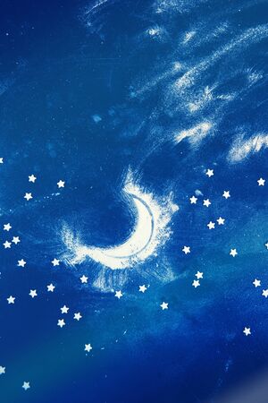 Night sky and moon: composition made of flour and candy stars on dark blue background. Vertical orientationの写真素材