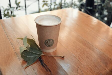 Paper coffee cup from coffee shop on wooden backgroundのeditorial素材