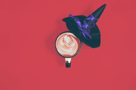 Halloween holiday concept with coffee cup and witch hatの写真素材