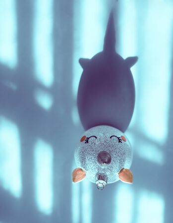 Christmas decoration unicorn ornament with shadow of a hornの写真素材