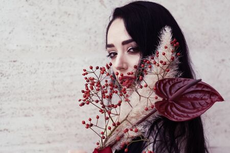 Outdoor portrait of a young glamorous fashionable woman posing on the street.の写真素材