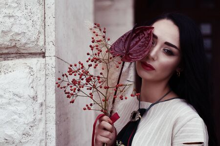 Outdoor portrait of a young glamorous fashionable woman posing on the street.の写真素材