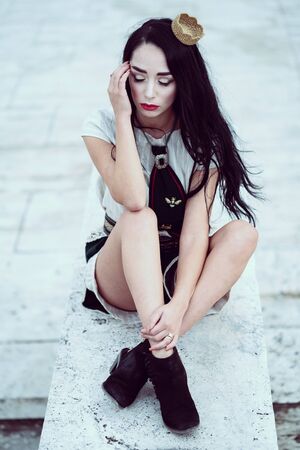 Outdoor conceptual street portrait of a young glamorous fashionable womanの写真素材