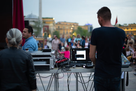 A girl is taking pictures of a street concert on the phoneのeditorial素材