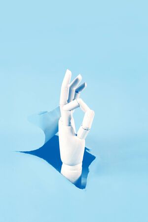 Hand through the hole in paperの写真素材