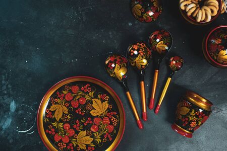 Russian khokhloma set, traditional wood painting handicraft souvenirs top view black backgroundの写真素材