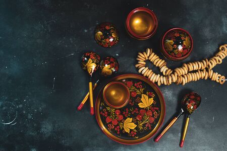 Russian khokhloma set, traditional wood painting handicraft souvenirs top view black backgroundの写真素材